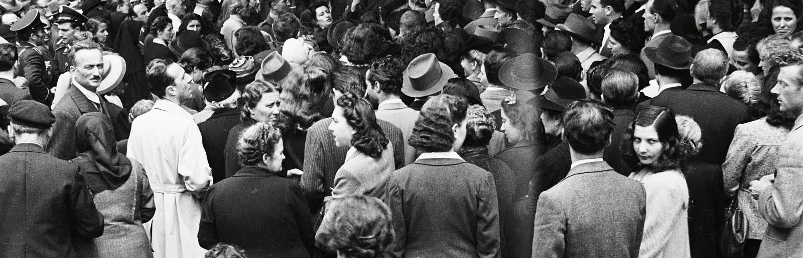 Immagine storica: folla di uomini e donne all'ingresso dei seggi elettorali del 2 giugno 1946